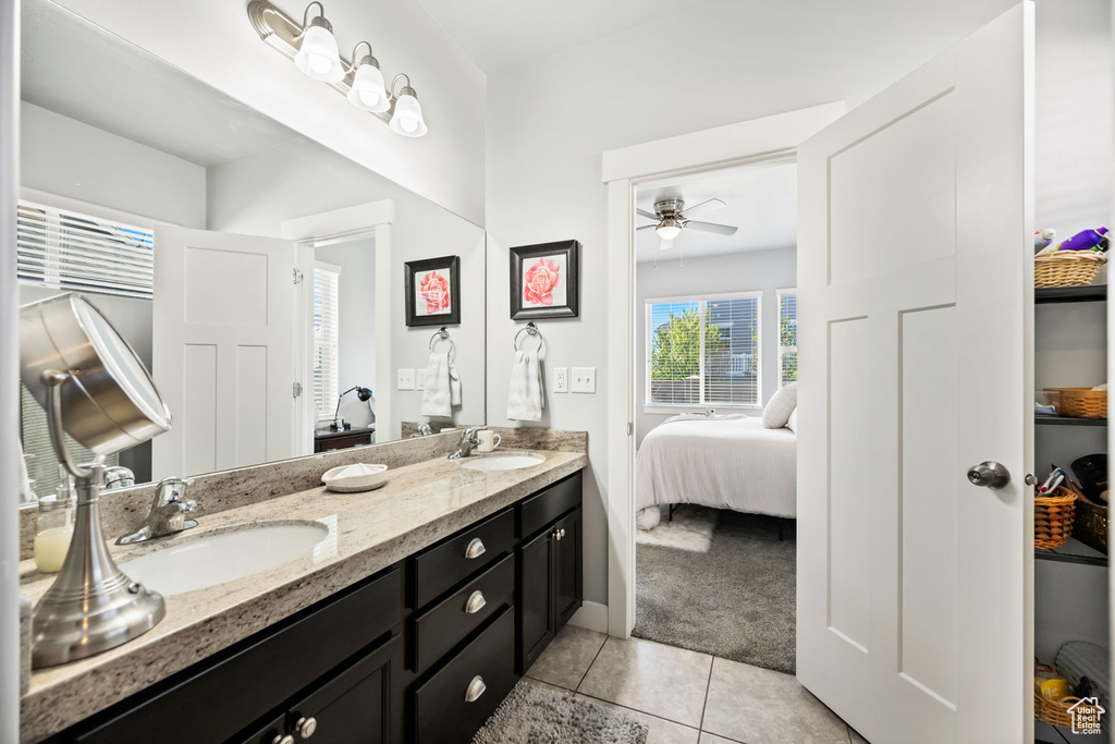 Full bath featuring a ceiling fan, ensuite bathroom, a sink, tile patterned flooring, and double vanity