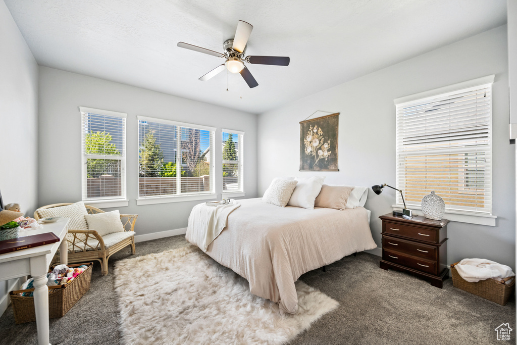 Carpeted bedroom with baseboards and ceiling fan
