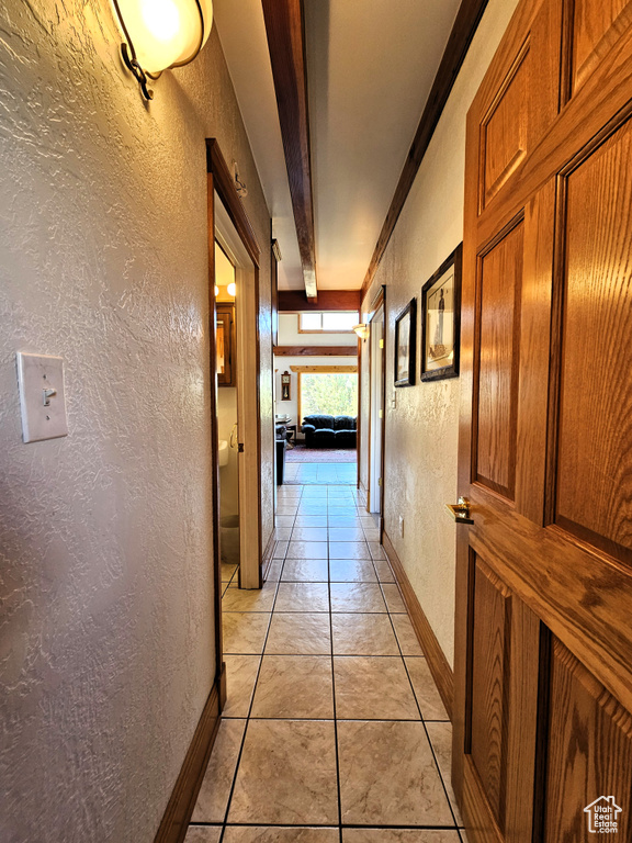 Hall with baseboards and a textured wall