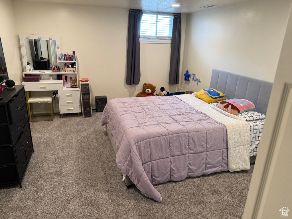 Carpeted bedroom with visible vents