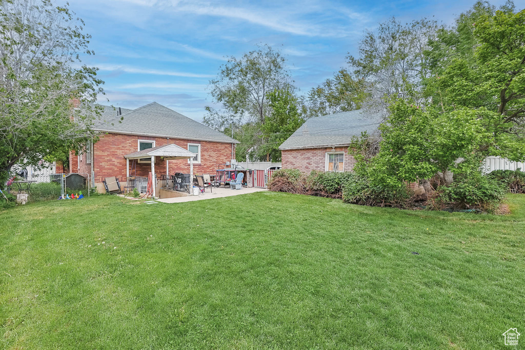 View of yard with a patio area