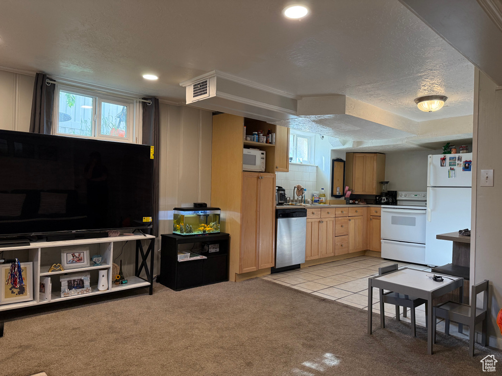 Kitchen with white appliances, light colored carpet, a textured ceiling, open shelves, and light brown cabinets