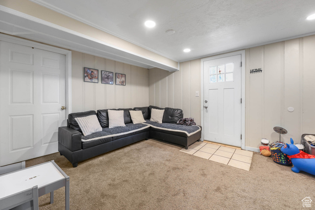 Living room with carpet floors and a decorative wall