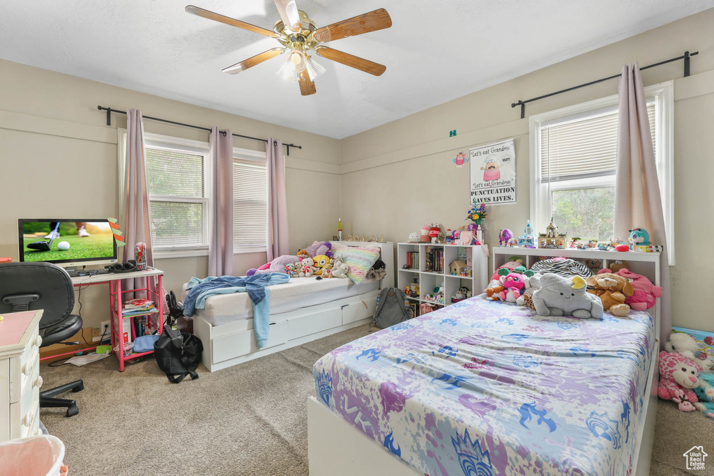 Carpeted bedroom with ceiling fan