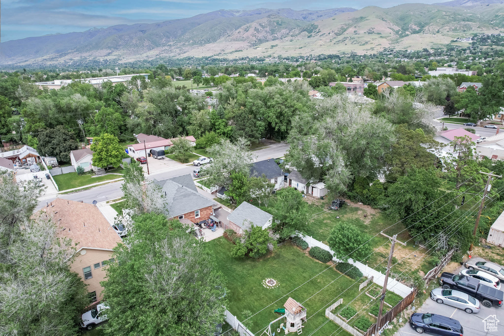 Aerial view of property's location with a mountainous background and nearby suburban area