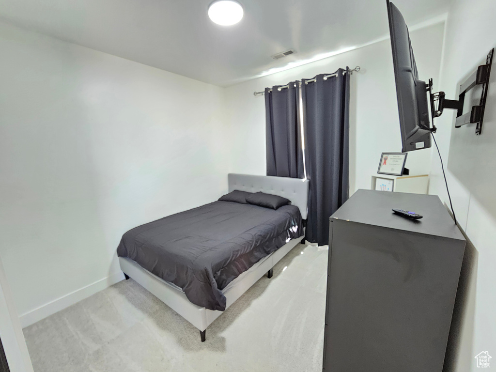 Bedroom featuring baseboards and visible vents