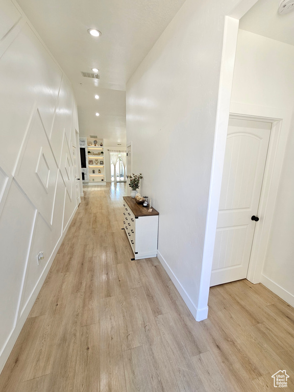 Hall with light wood-style floors, recessed lighting, baseboards, and visible vents