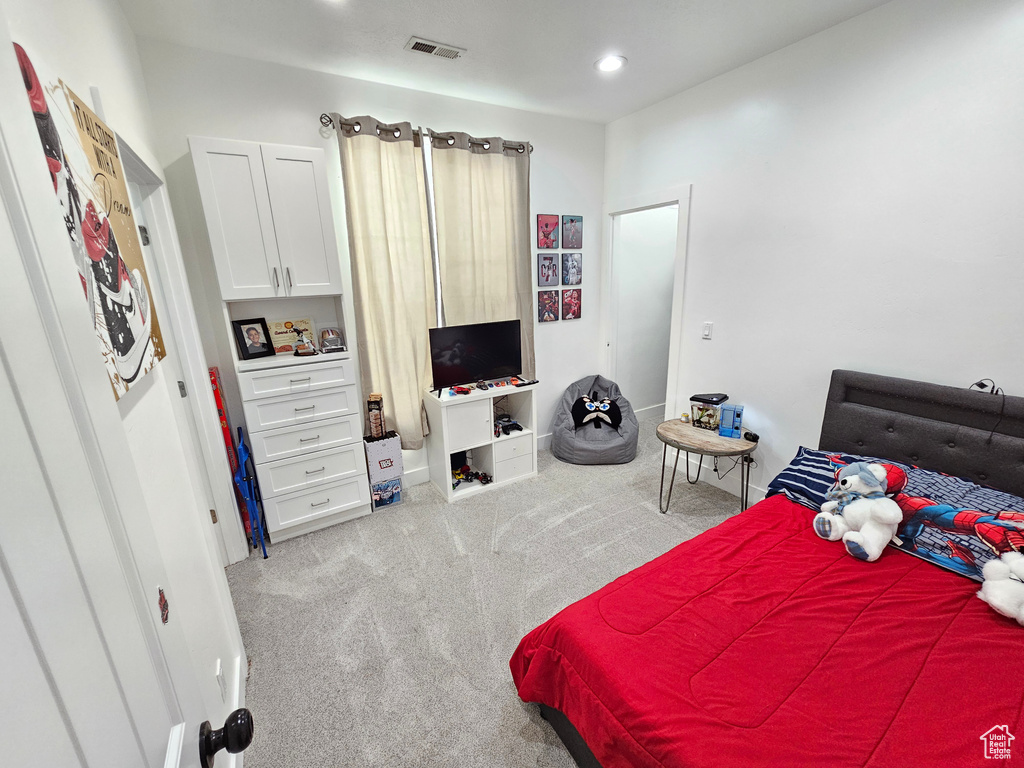 Bedroom with carpet floors, baseboards, and visible vents
