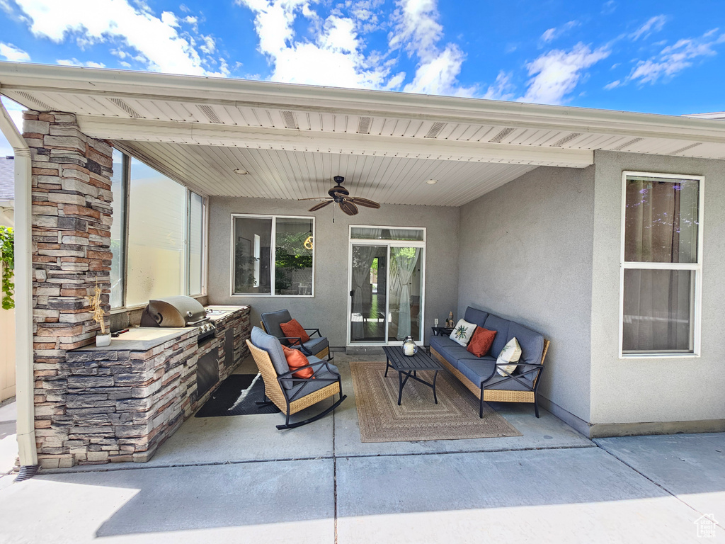 View of patio / terrace featuring an outdoor kitchen and ceiling fan