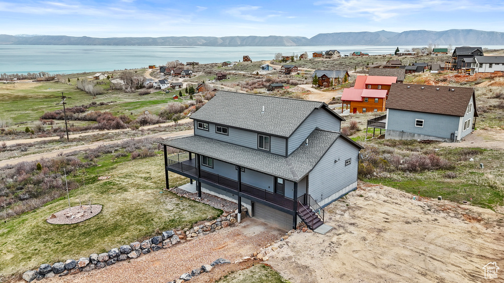 Drone / aerial view featuring a water and mountain view