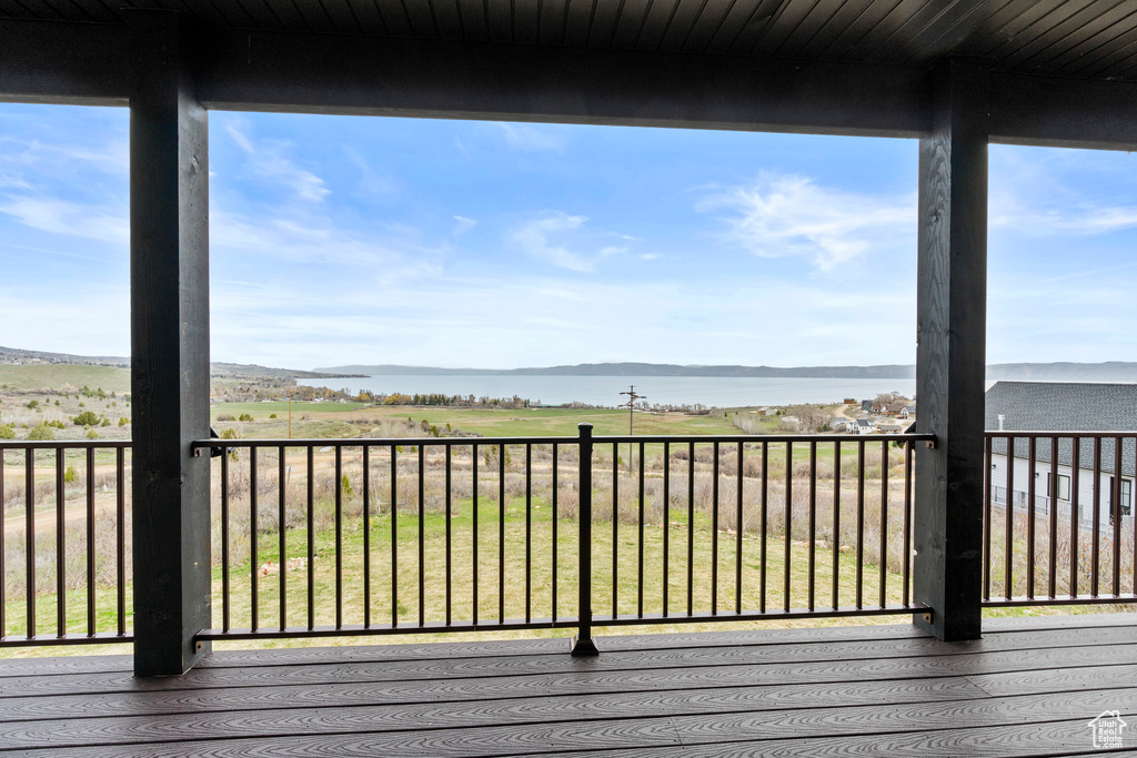 Wooden deck featuring a water and mountain view