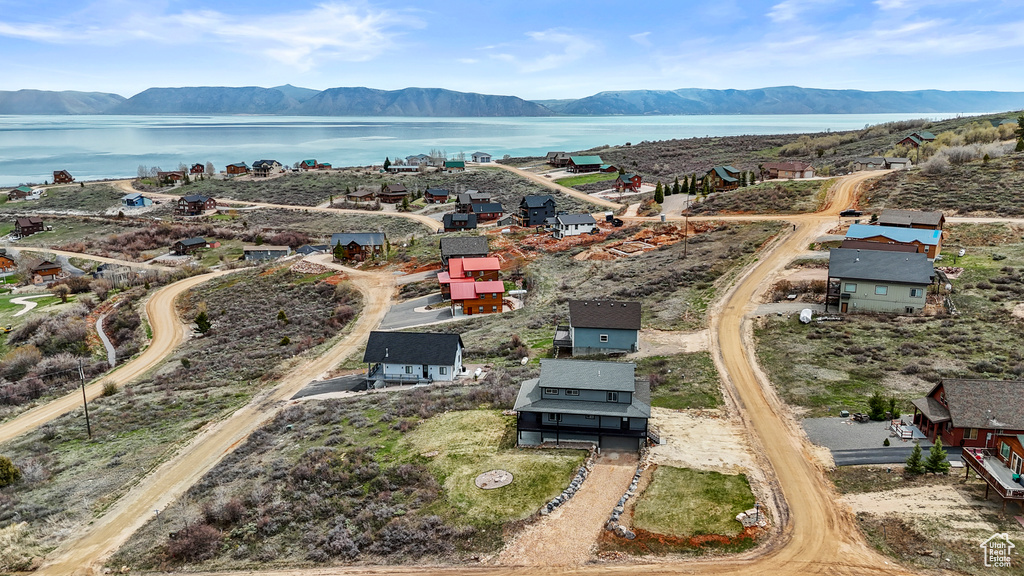 Birds eye view of property featuring a water and mountain view
