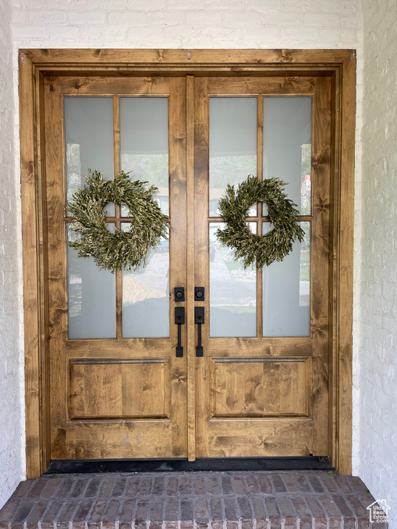 View of exterior entry featuring french doors