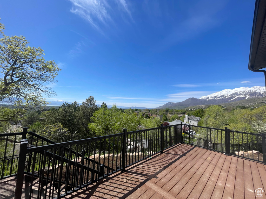 Wooden terrace featuring stairway and a mountain view