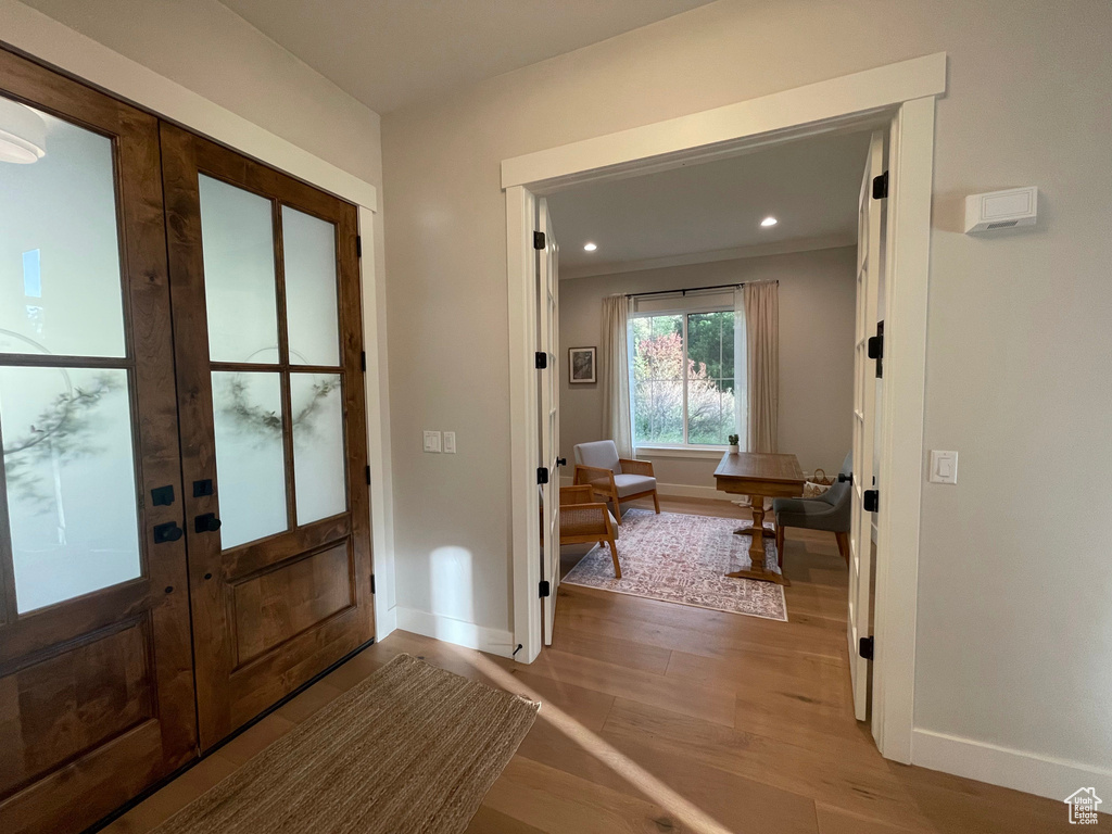 Doorway to outside featuring baseboards, french doors, light wood-style flooring, and recessed lighting