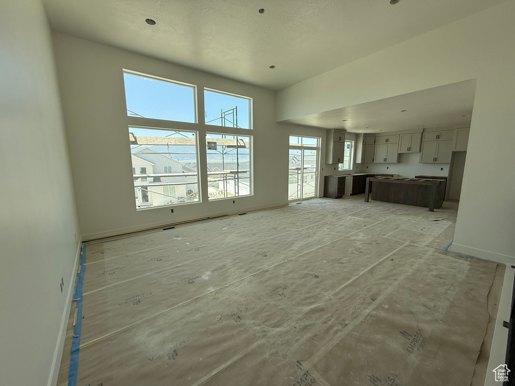 Unfurnished living room with baseboards