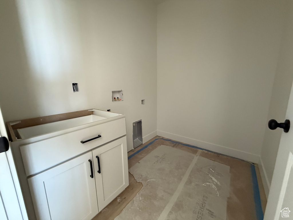 Laundry room featuring hookup for a washing machine, cabinet space, and hookup for an electric dryer
