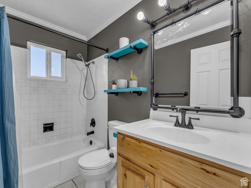 Full bath featuring shower / tub combo, toilet, tile patterned floors, vanity, and crown molding