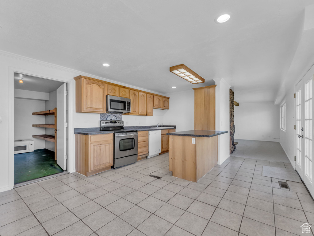 Kitchen with dark countertops, visible vents, appliances with stainless steel finishes, light tile patterned flooring, and recessed lighting