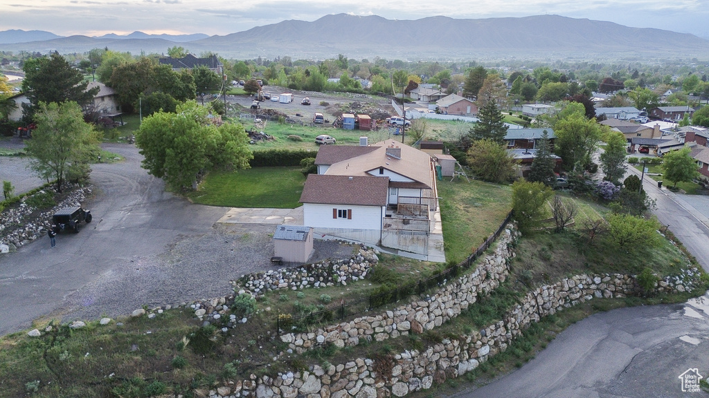 Aerial view of property and surrounding area featuring mountains
