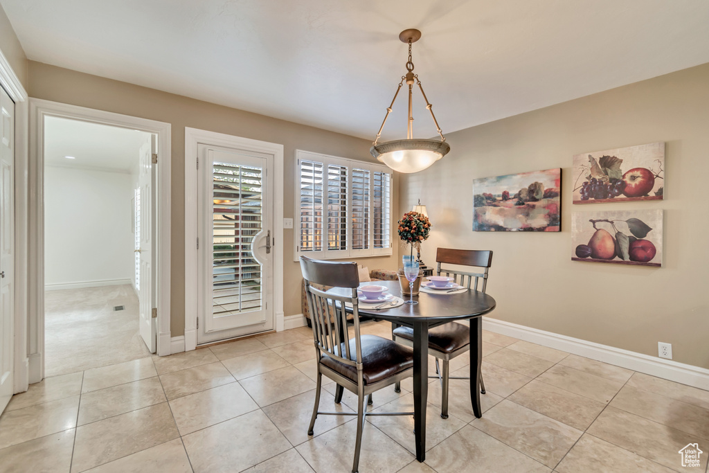 Dining area with baseboards and light tile patterned flooring