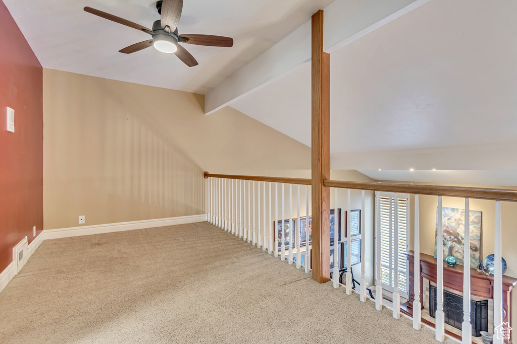Bonus room with carpet, a ceiling fan, visible vents, and vaulted ceiling with beams