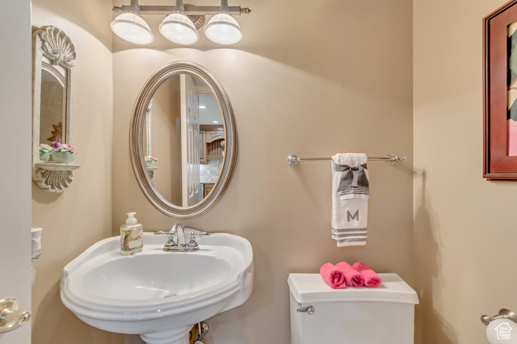 Half bath featuring a sink and toilet