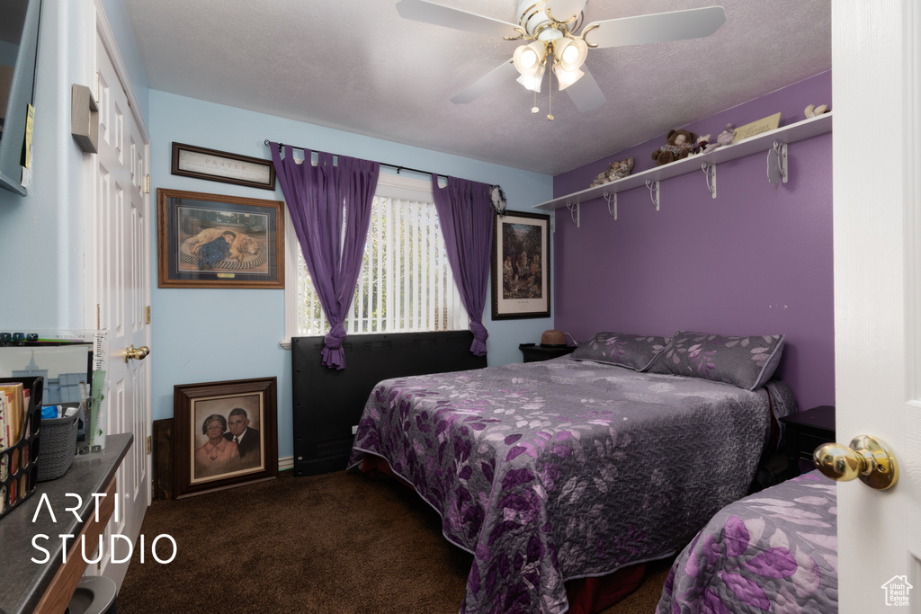 Bedroom with a ceiling fan and carpet floors