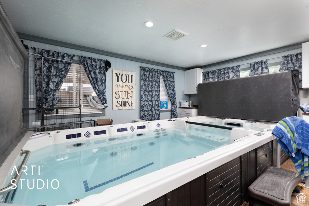 Interior space with crown molding, visible vents, and recessed lighting