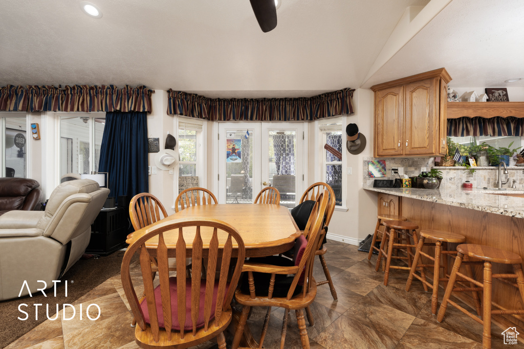 Dining space with lofted ceiling and recessed lighting