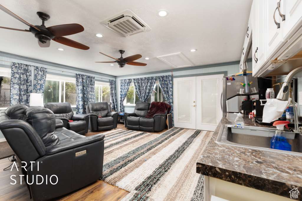 Living area with wood finished floors, attic access, visible vents, recessed lighting, and ceiling fan