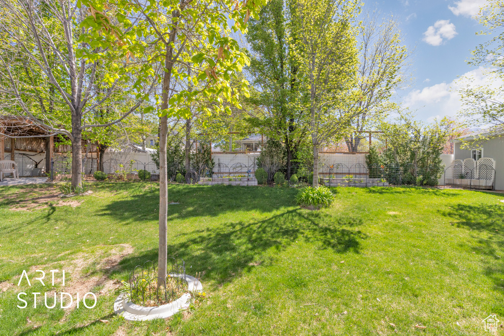 View of yard featuring fence