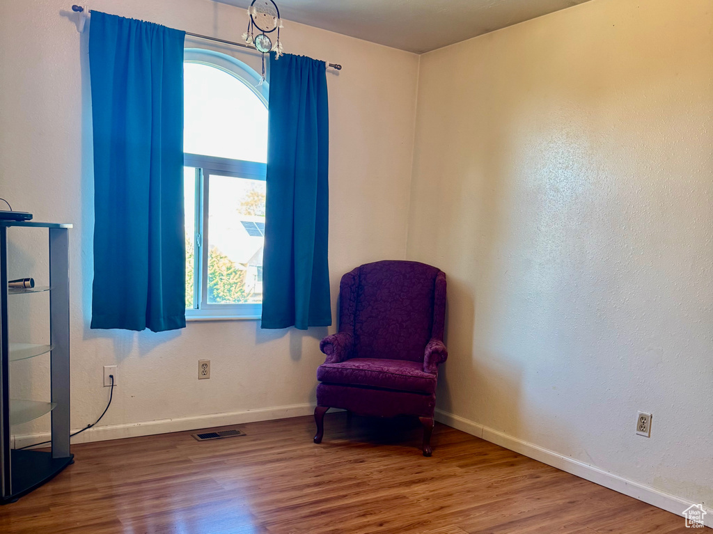 Unfurnished room featuring wood finished floors, a textured ceiling, and baseboards