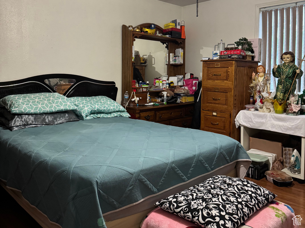 Bedroom featuring a textured ceiling, wood finished floors, and ceiling fan