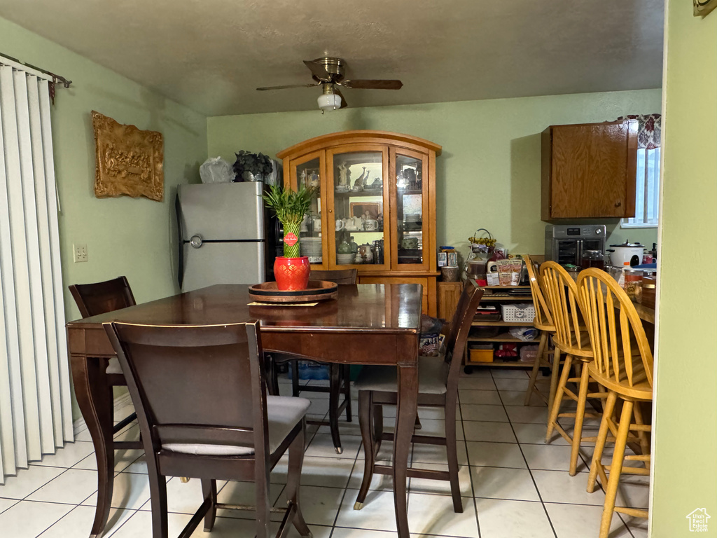 Dining room featuring a ceiling fan and light tile patterned floors