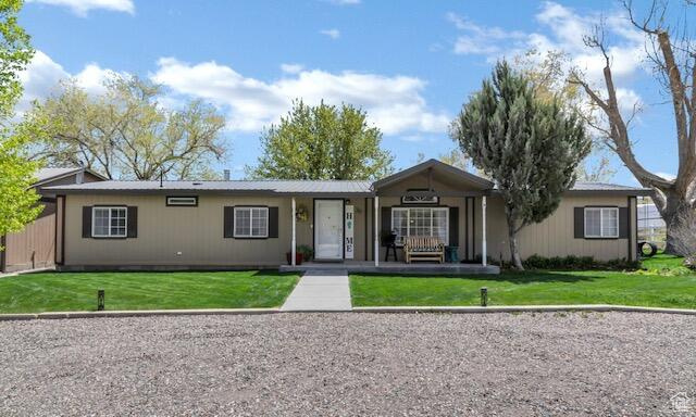 Ranch-style house with a front lawn