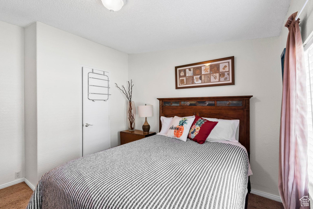 Carpeted bedroom with baseboards