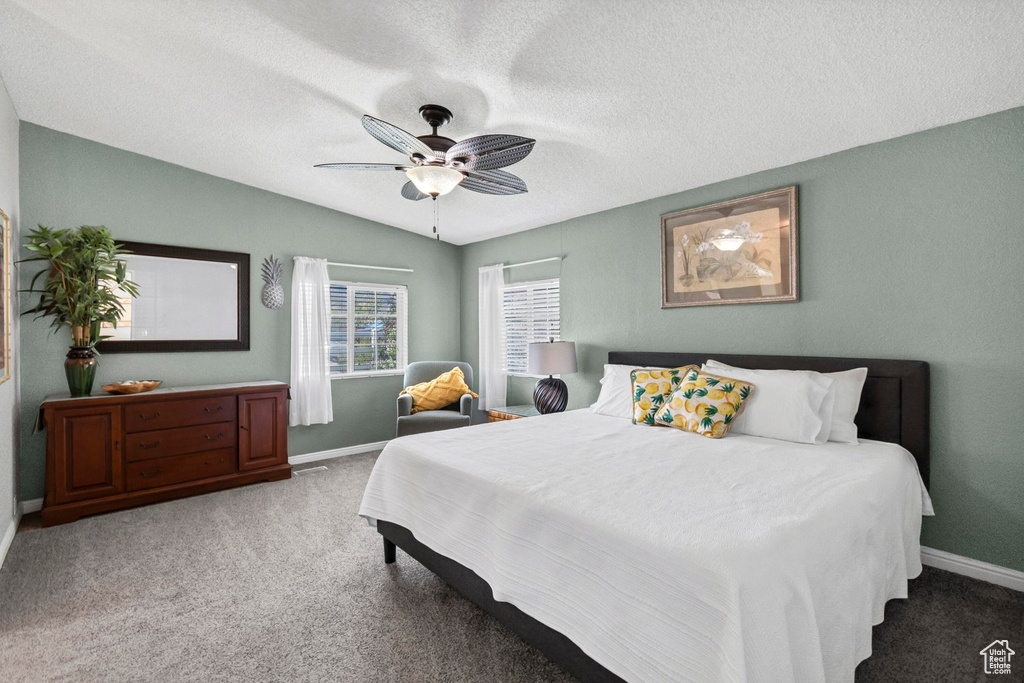 Bedroom featuring a textured ceiling, baseboards, ceiling fan, and carpet floors