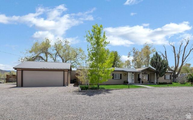 Ranch-style home with gravel driveway and an attached garage