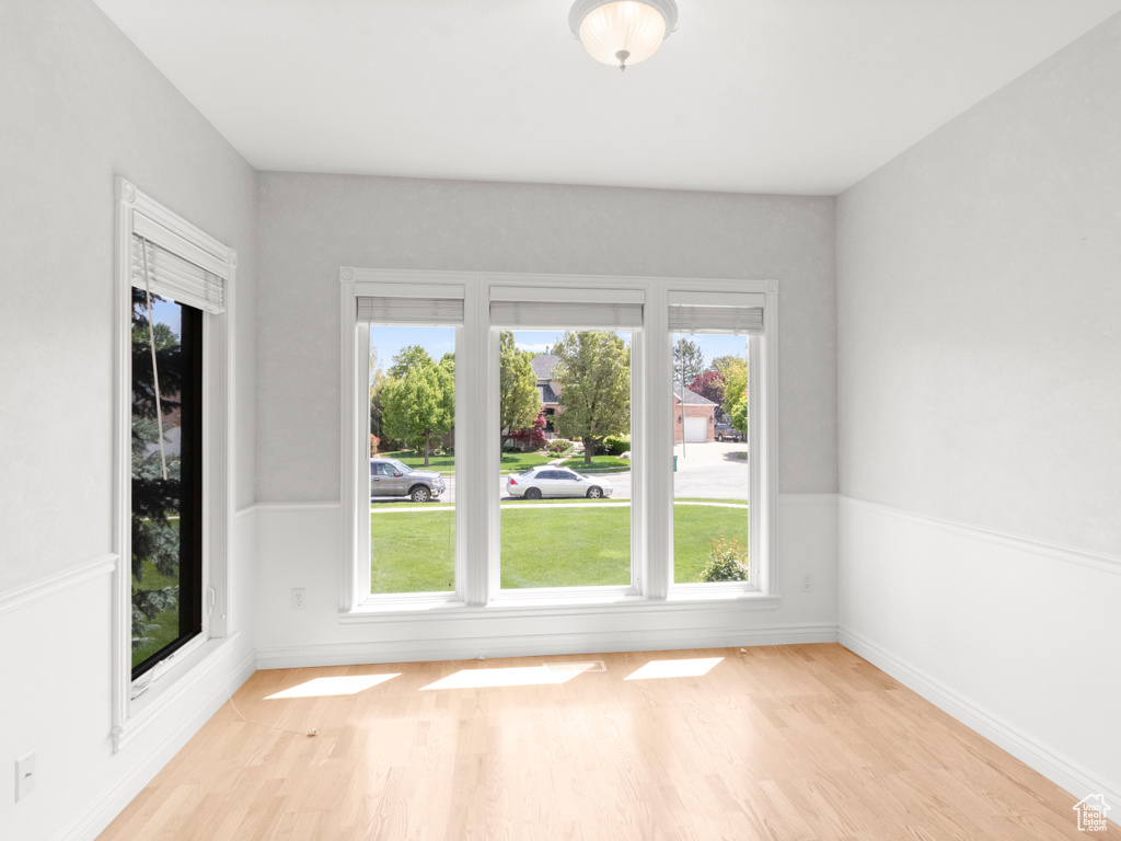 Unfurnished room with baseboards and light wood-type flooring