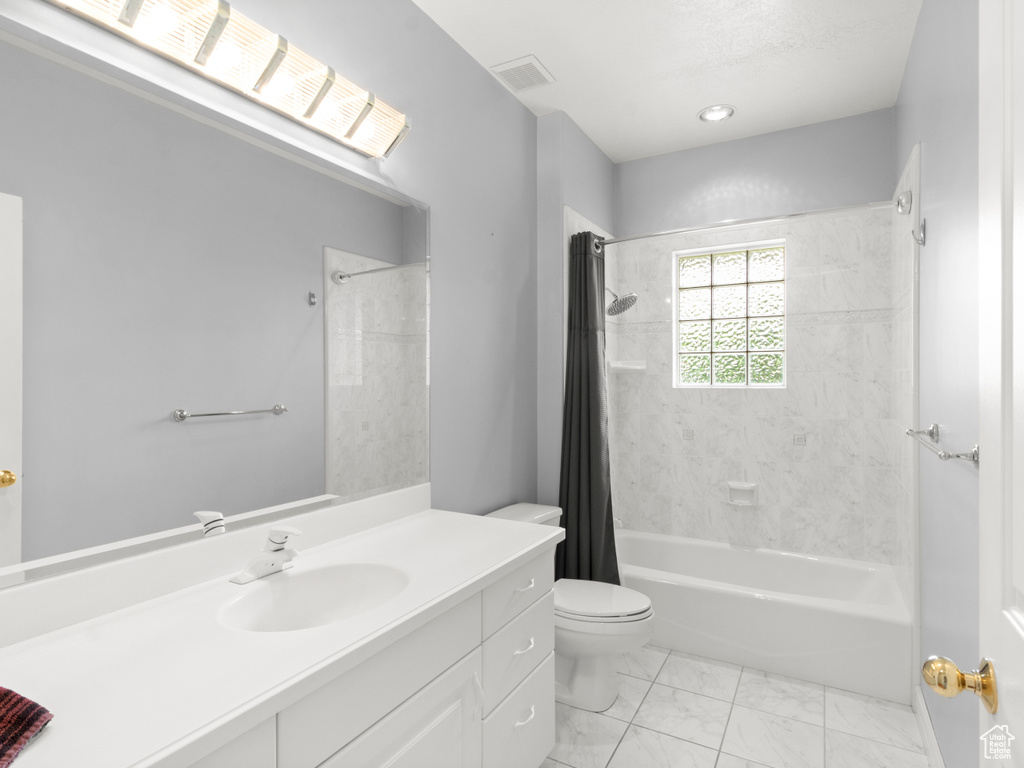 Bathroom with toilet, marble finish floor, vanity, shower / tub combo with curtain, and visible vents
