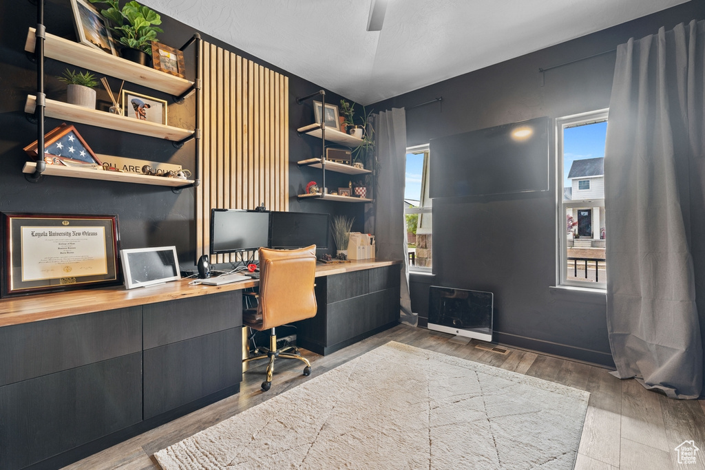 Office space with built in study area and wood finished floors
