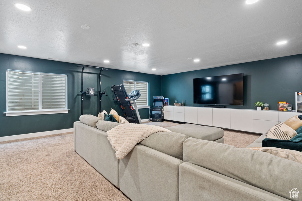 Carpeted living area featuring baseboards and recessed lighting