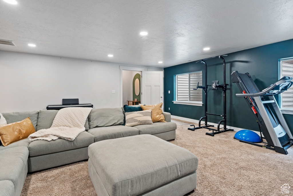 Living area featuring baseboards, visible vents, recessed lighting, and carpet floors