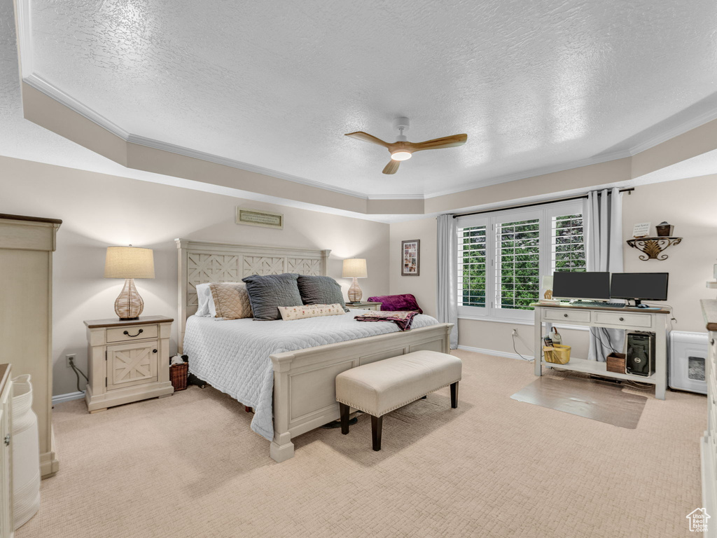 Bedroom featuring light colored carpet, a textured ceiling, ceiling fan, and baseboards