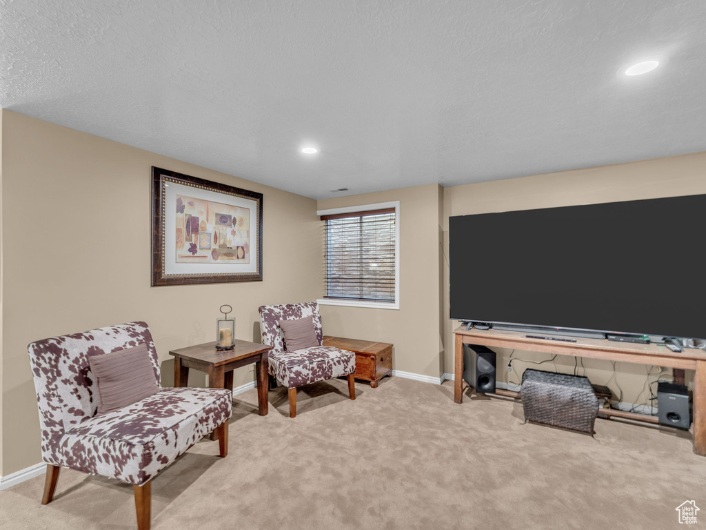 Living area featuring recessed lighting, baseboards, and carpet
