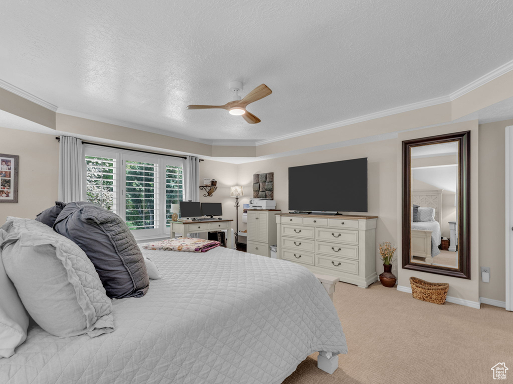 Bedroom featuring ornamental molding and a textured ceiling