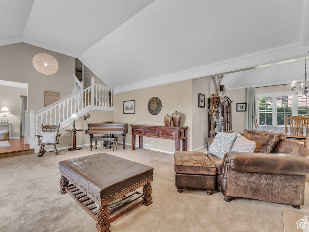 Carpeted living area featuring stairway, baseboards, crown molding, and lofted ceiling