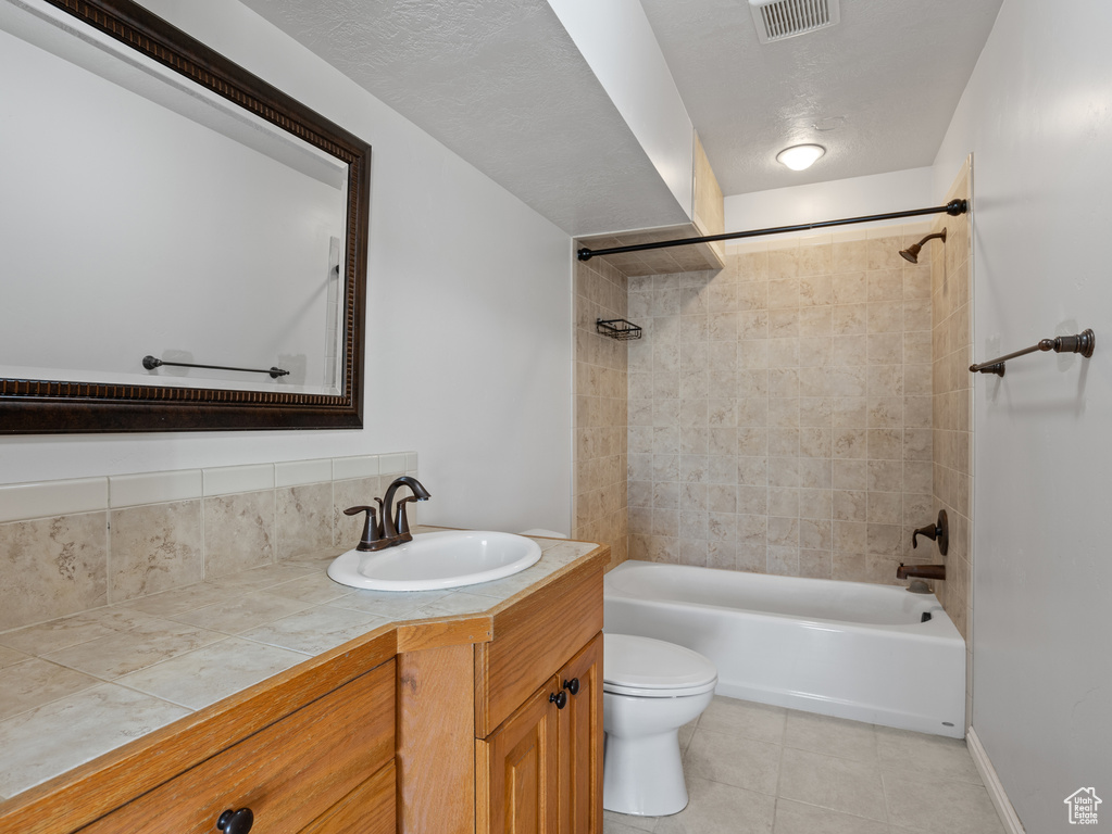 Bathroom featuring shower / bath combination, toilet, visible vents, tile patterned floors, and vanity
