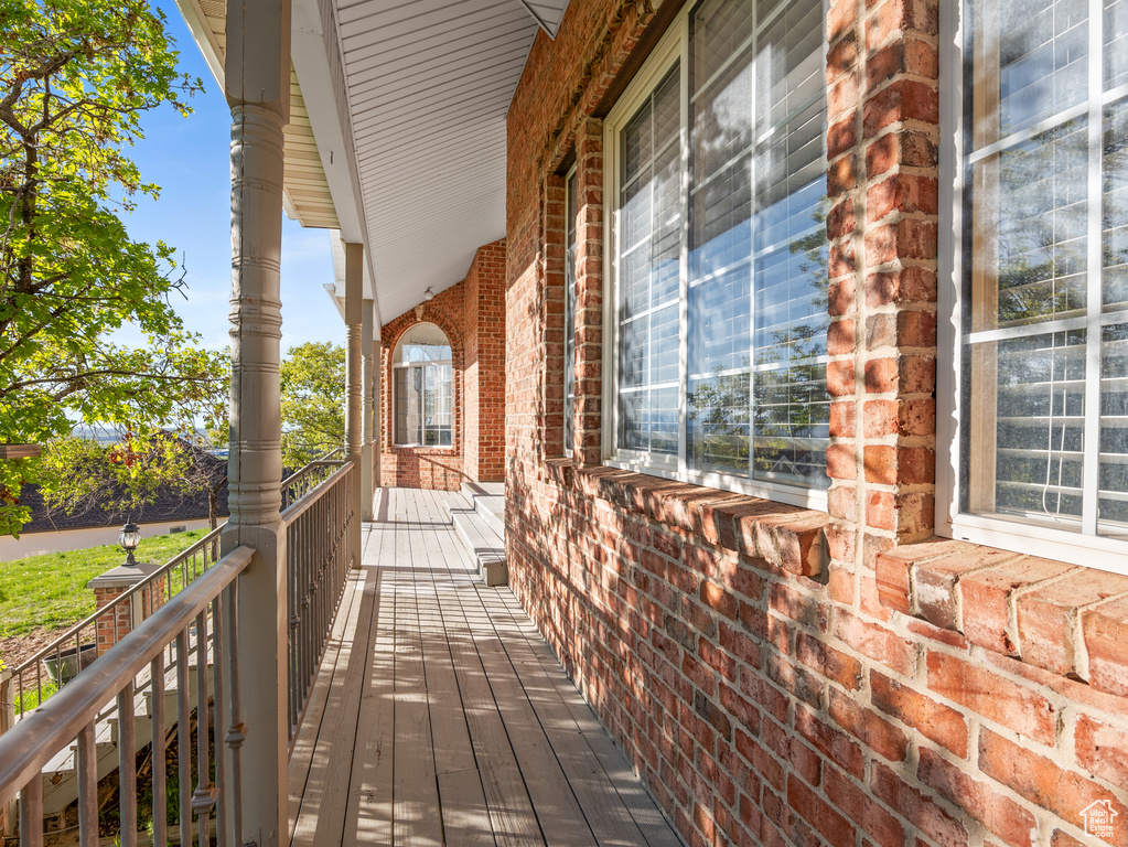 Exterior space with a porch and brick siding